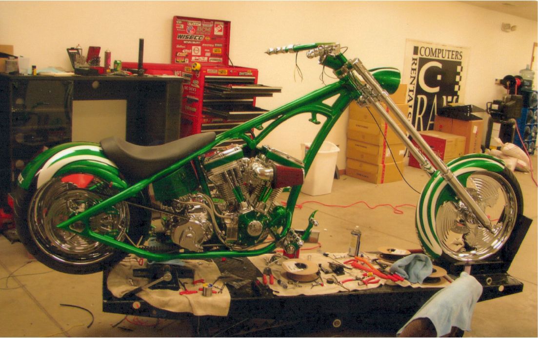 side view of customized green chopper with no fuel tank cover