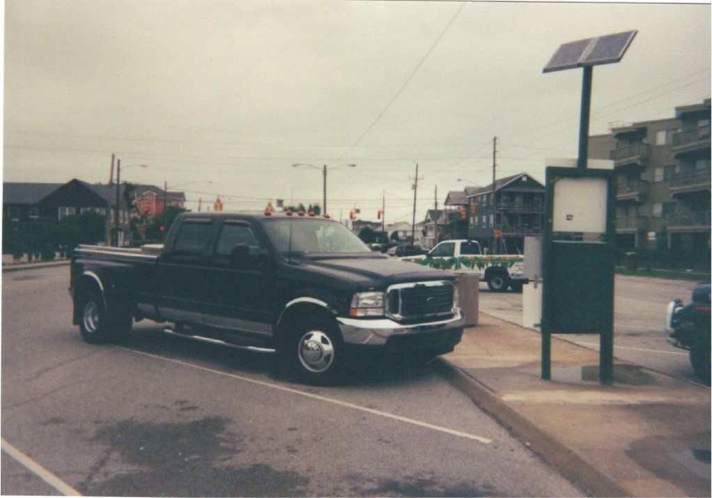 side front black ford pickup before customization in parking lot