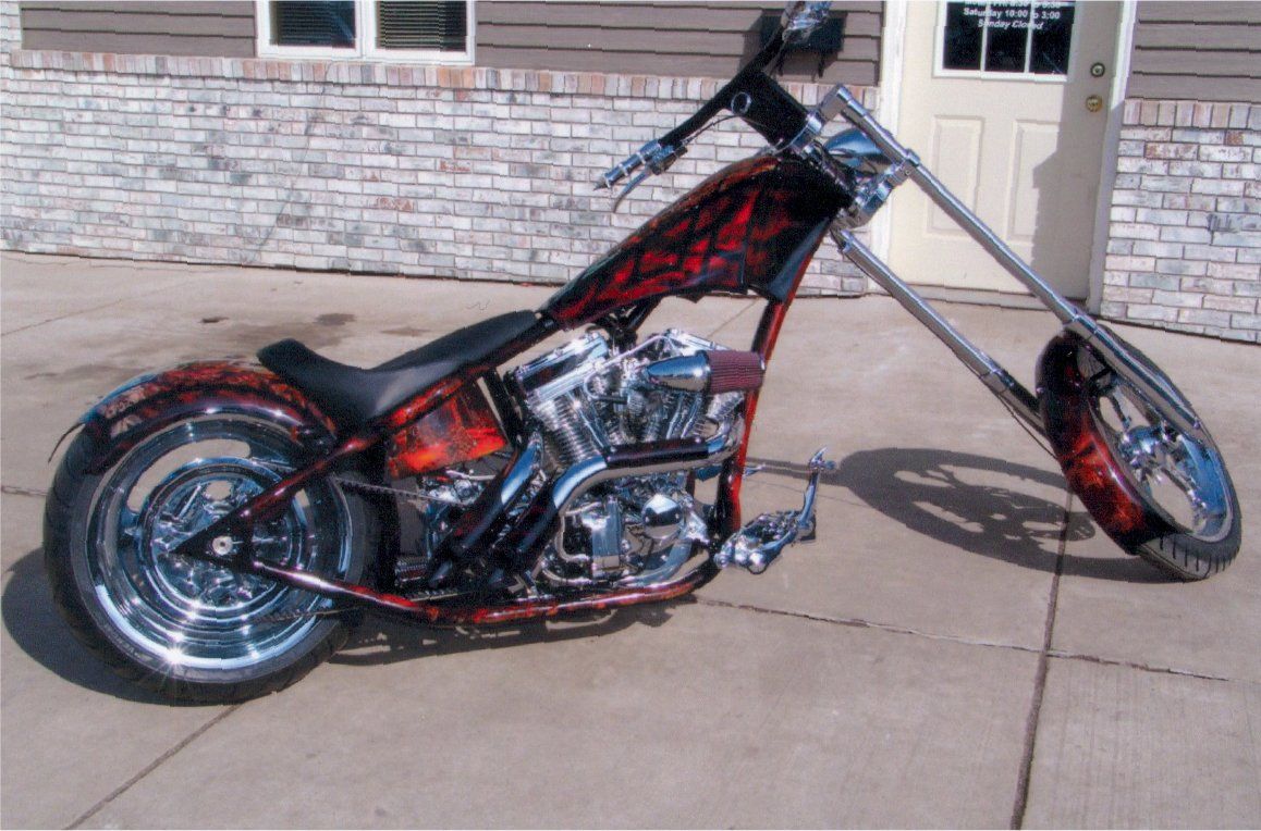 side view o customized red and chrome chopper