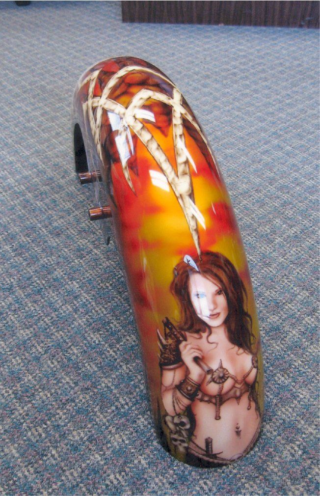 close up of custom orange and red fender art with brunette woman