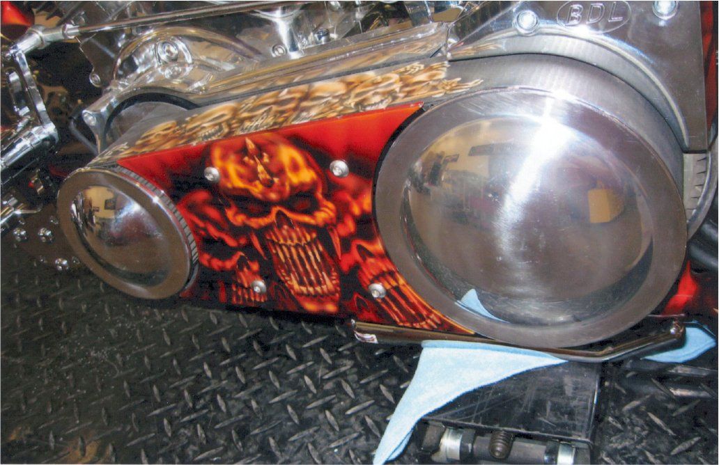 close up of detailed custom orange and red skull designs on chopper