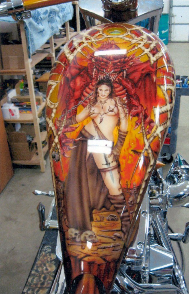 close up of pointed custom orange and red fender with woman warrior art