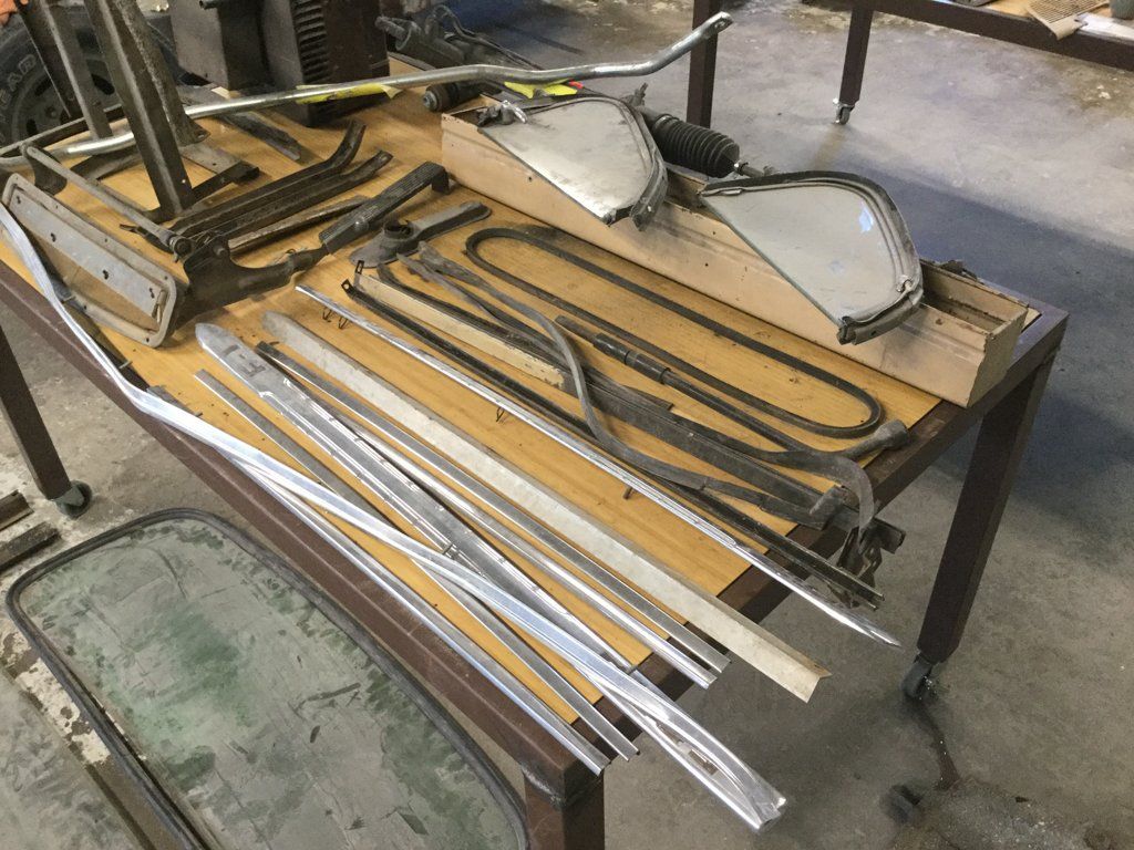 side view of truck parts and frames laid out on table