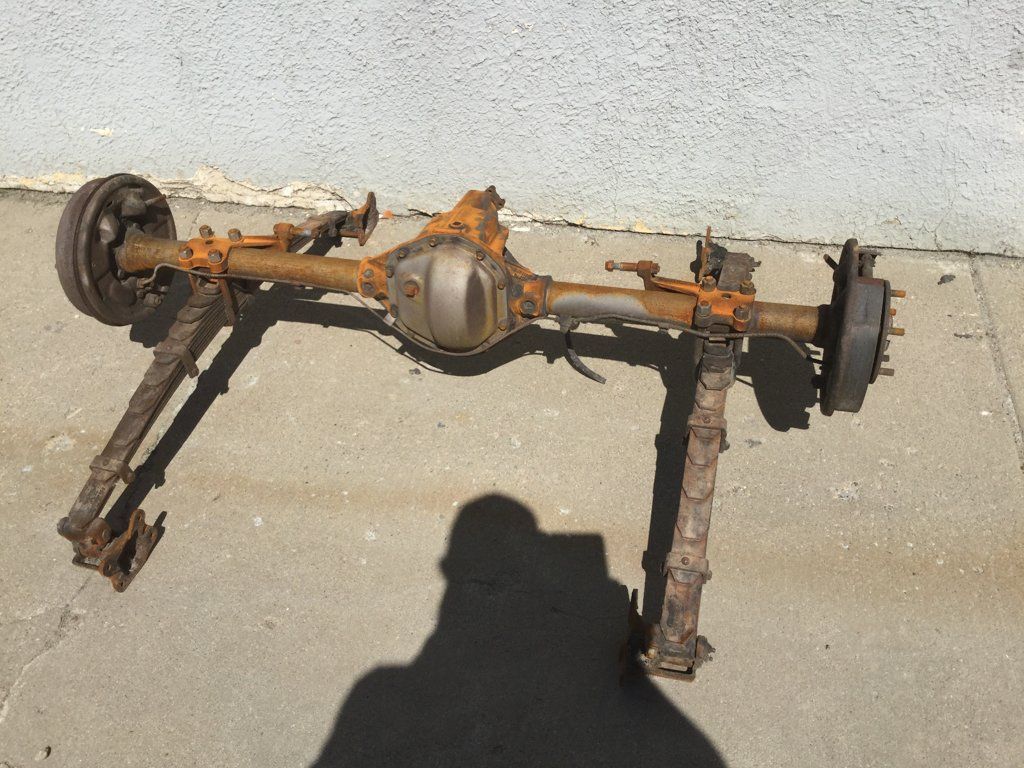 rusted truck axel removed from truck outside