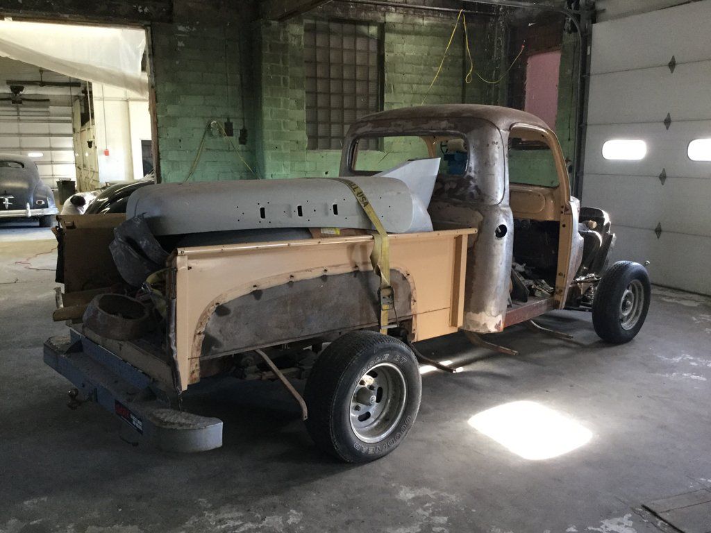 rear side view of truck with parts in bed