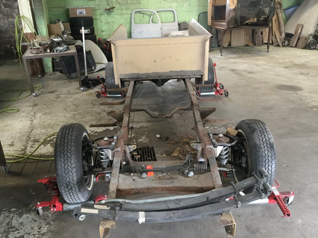 truck chasis with whels and bed on service bay