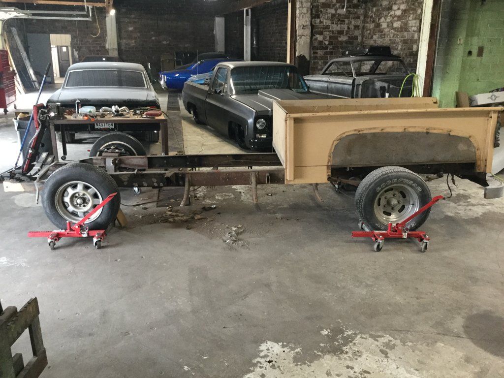 side view of truck chassis with wheels and bed on service bay