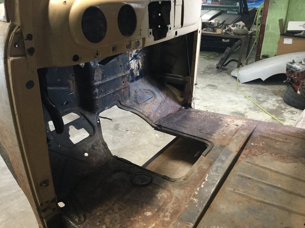 driver side view of truck floor with seats and pedals removed