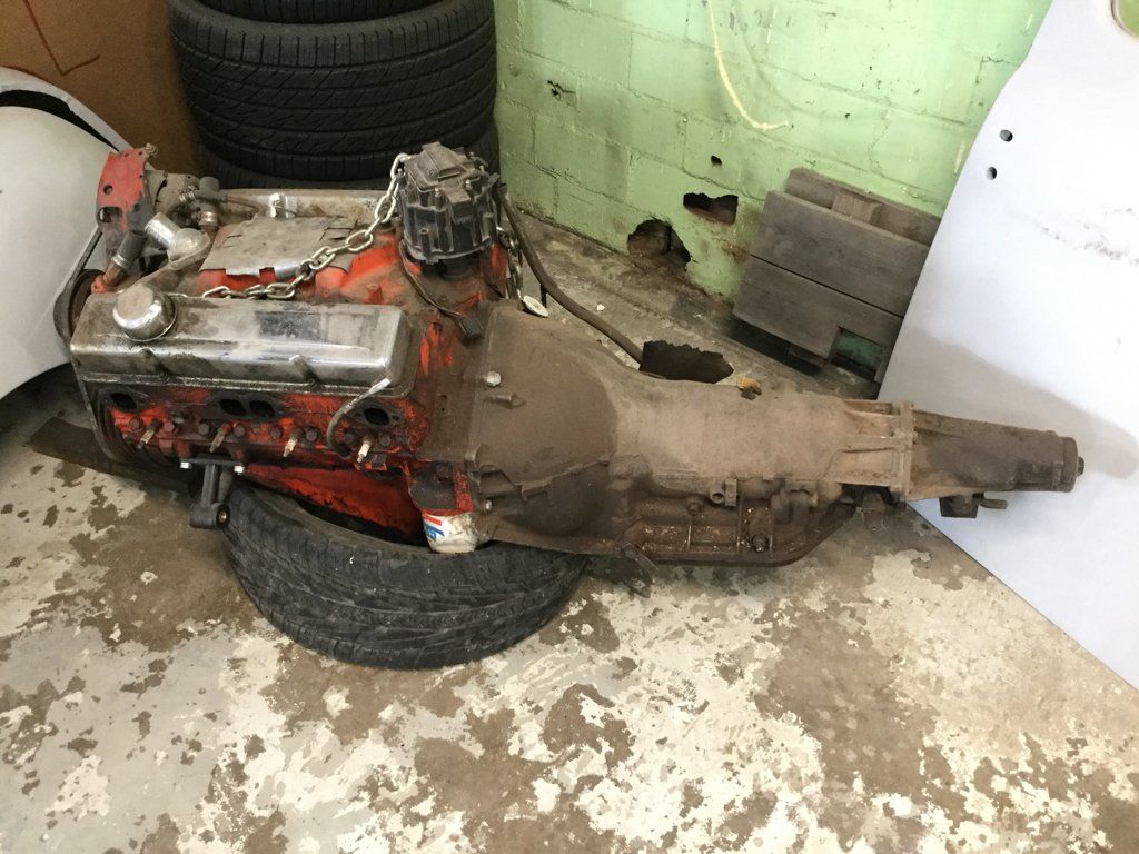 engine on floor on tire in corner of garage