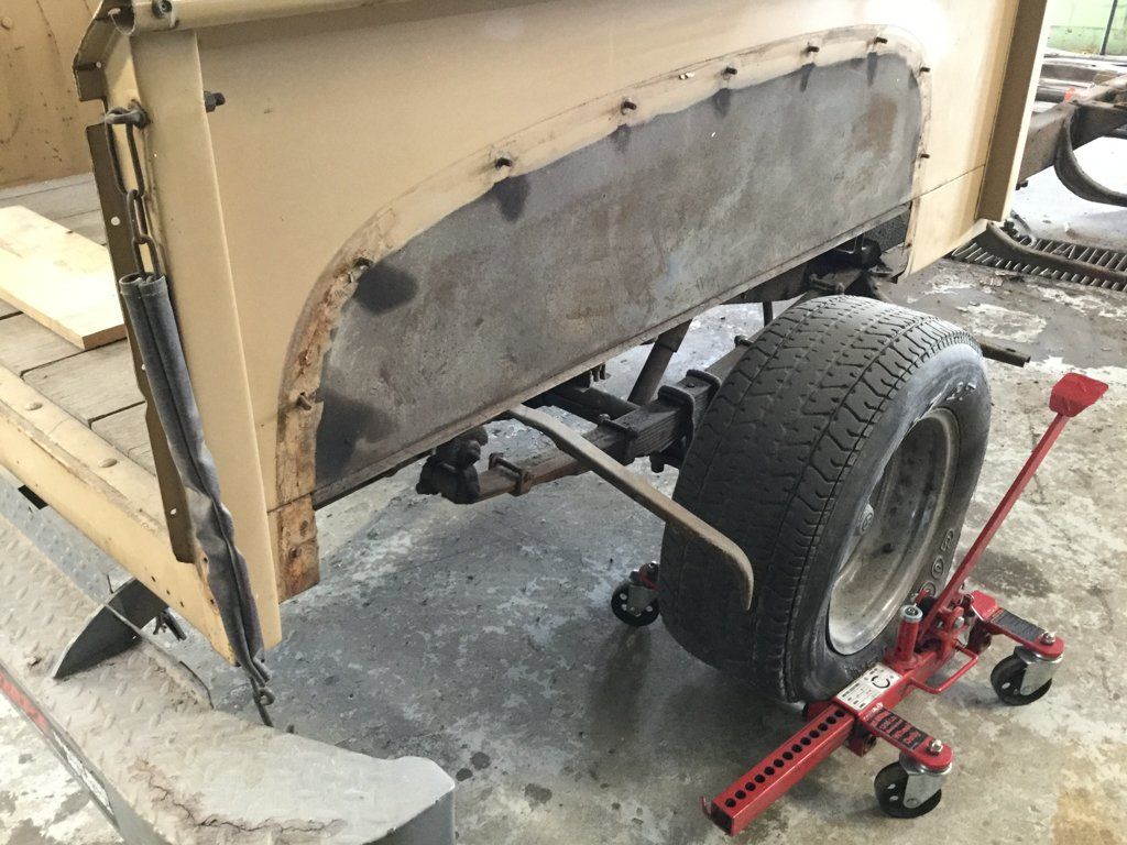 view of front truck fender removed and wheel suspended
