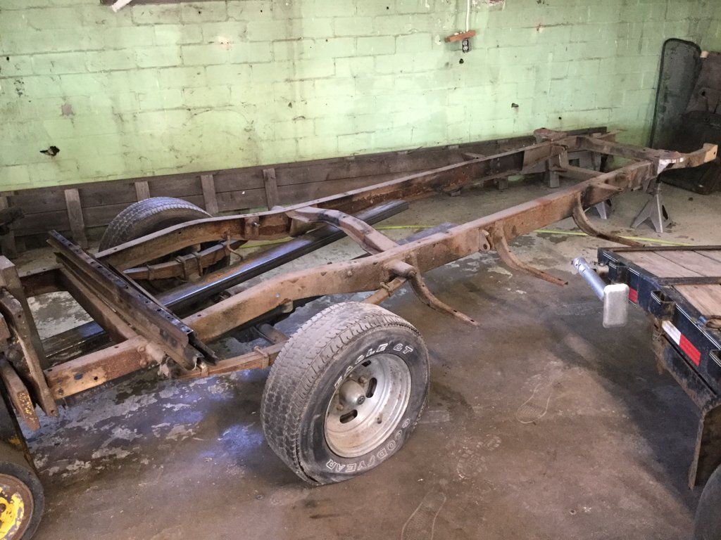 truck chasis with flat rear wheels in garage