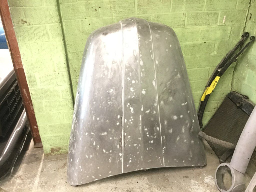 front view of truck hood removed against wall