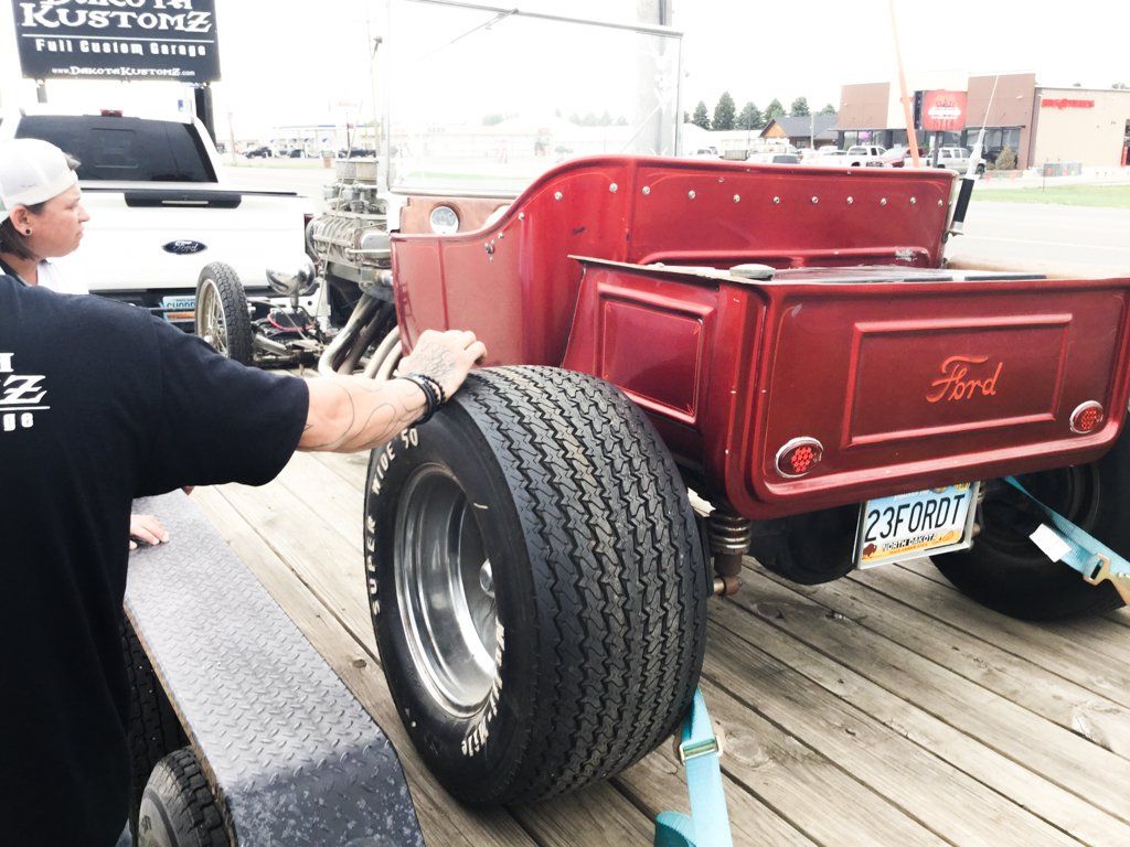 close up of rear tire with mechanic's hand on it