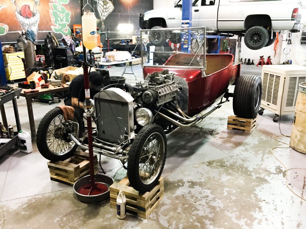 car suspended on crates with seats removed