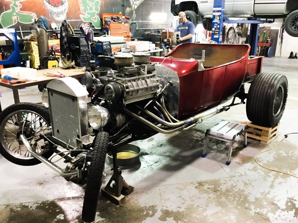 car with front hood removed on workbench