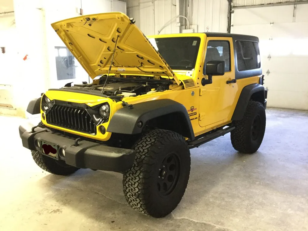 custom yellow jeep wrangler with hood open