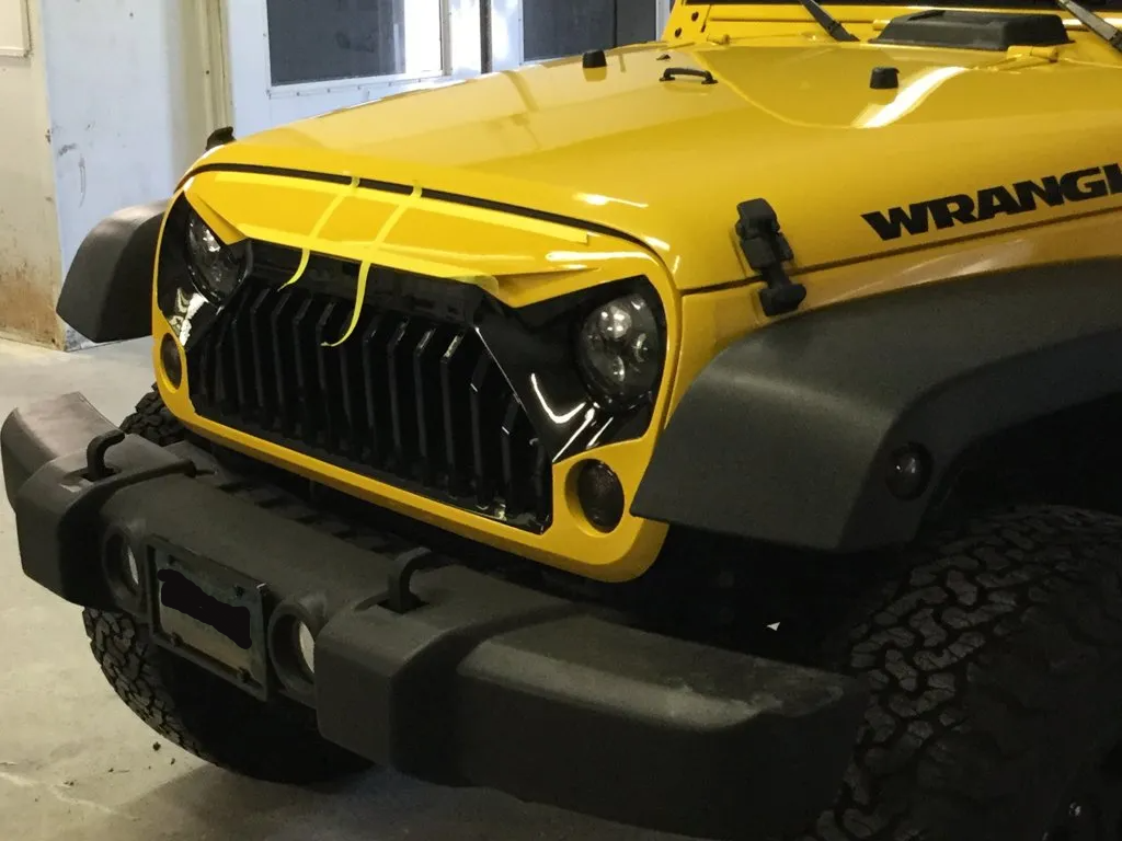 close up of custom 2015 yellow jeep wrangler front grill