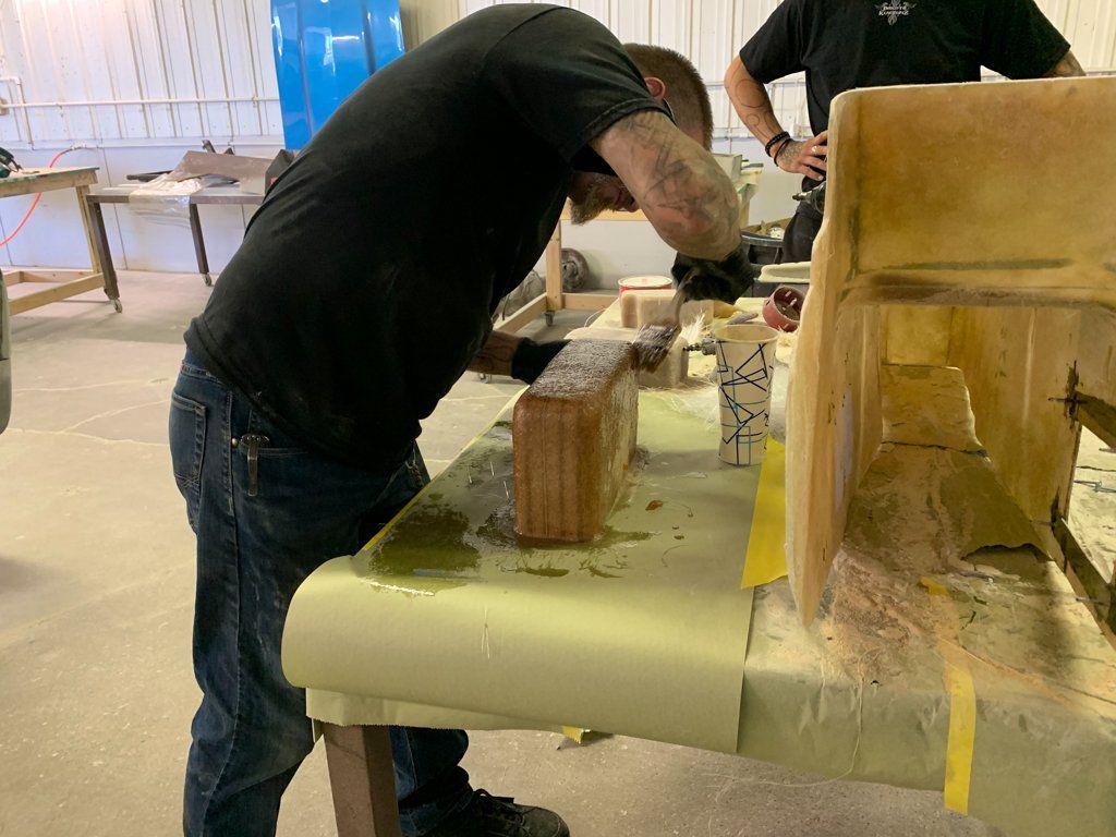 worker adding resin to wood