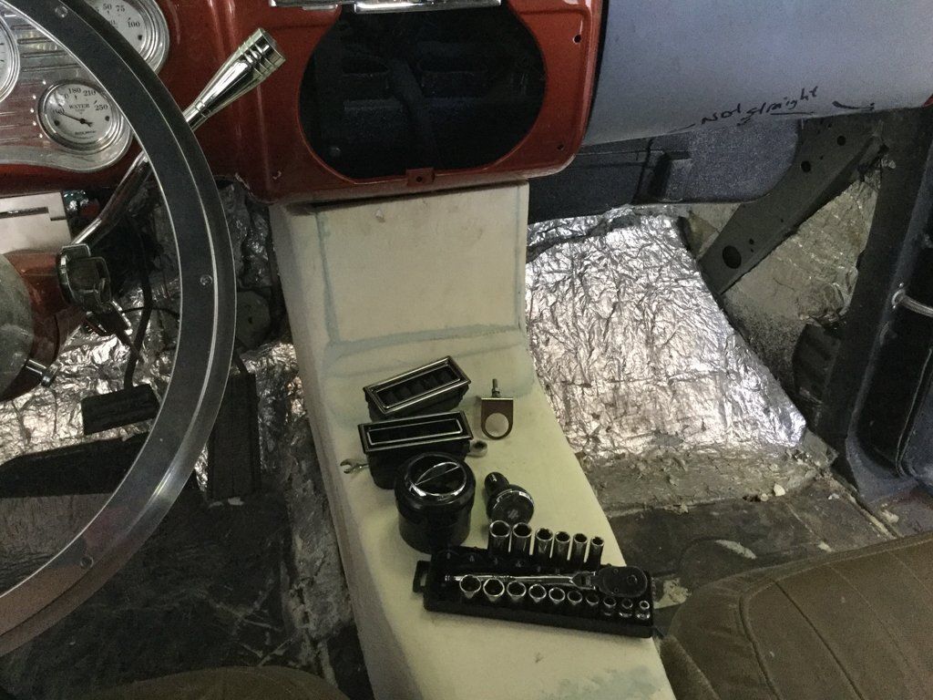 tools on top of central wooden console in car
