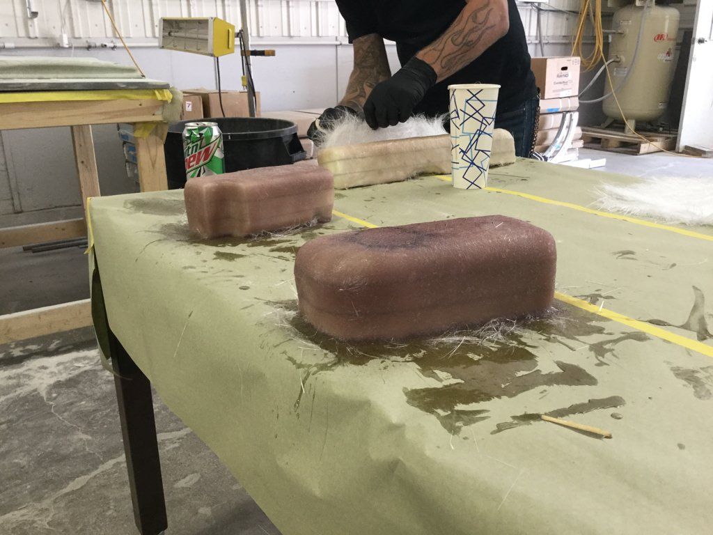 worker applying reside to car parts