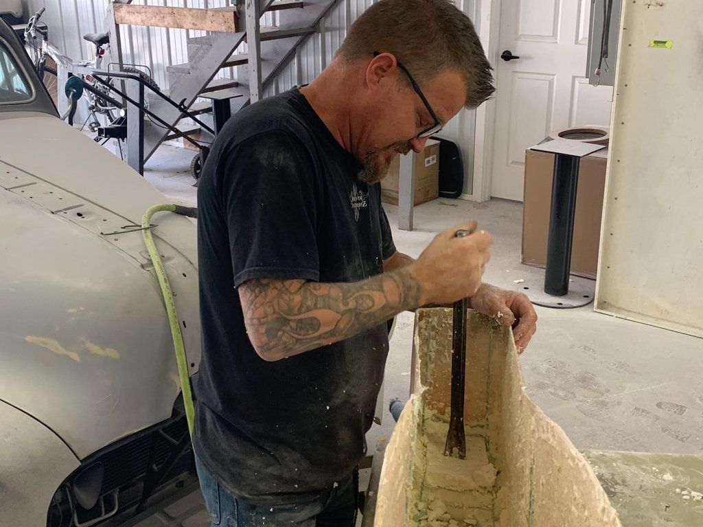 worker chiseling out mold