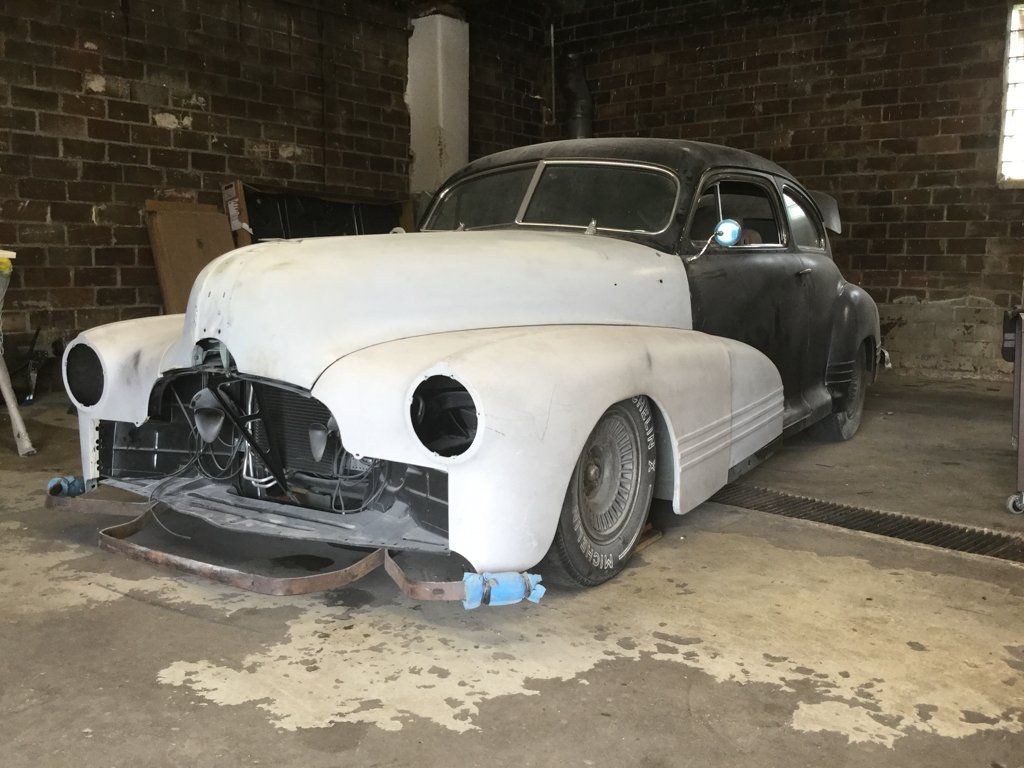 pontiac stripped of paint inside dark garage