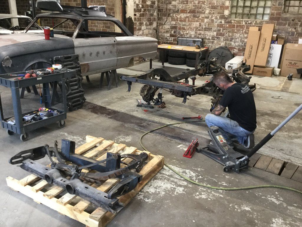 mechanic servicing car chasis