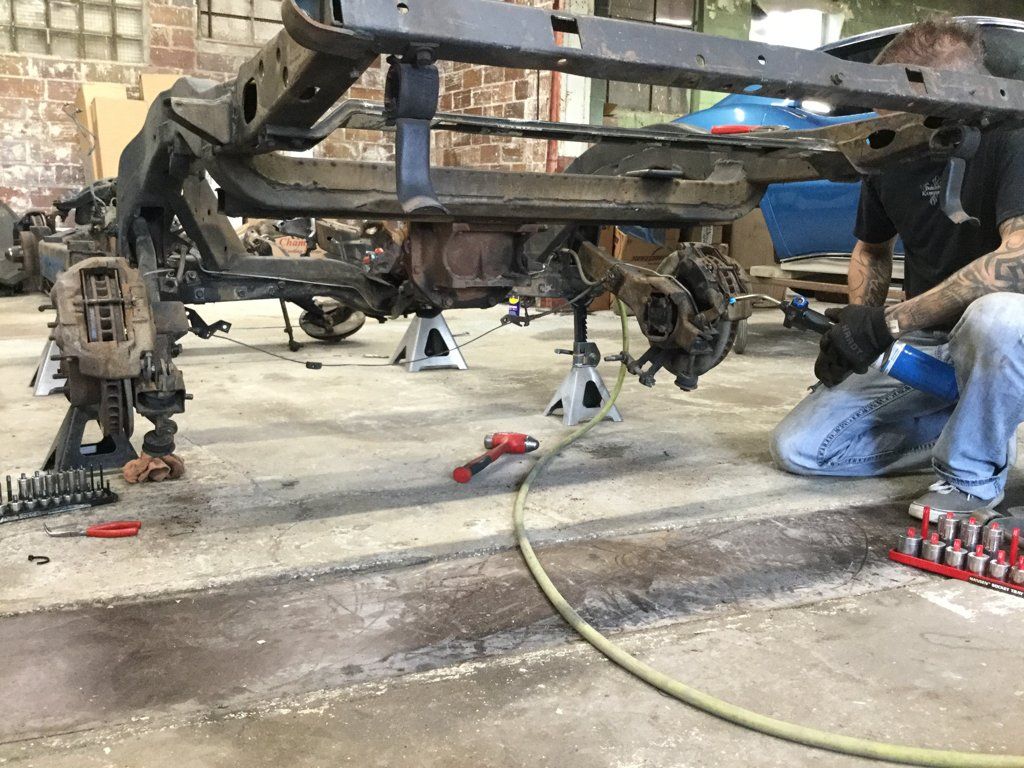 car chasis being raised on its side and serviced