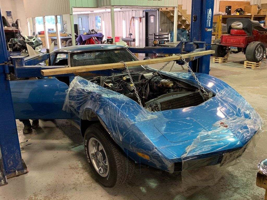 rear view of car body suspended next to service cart