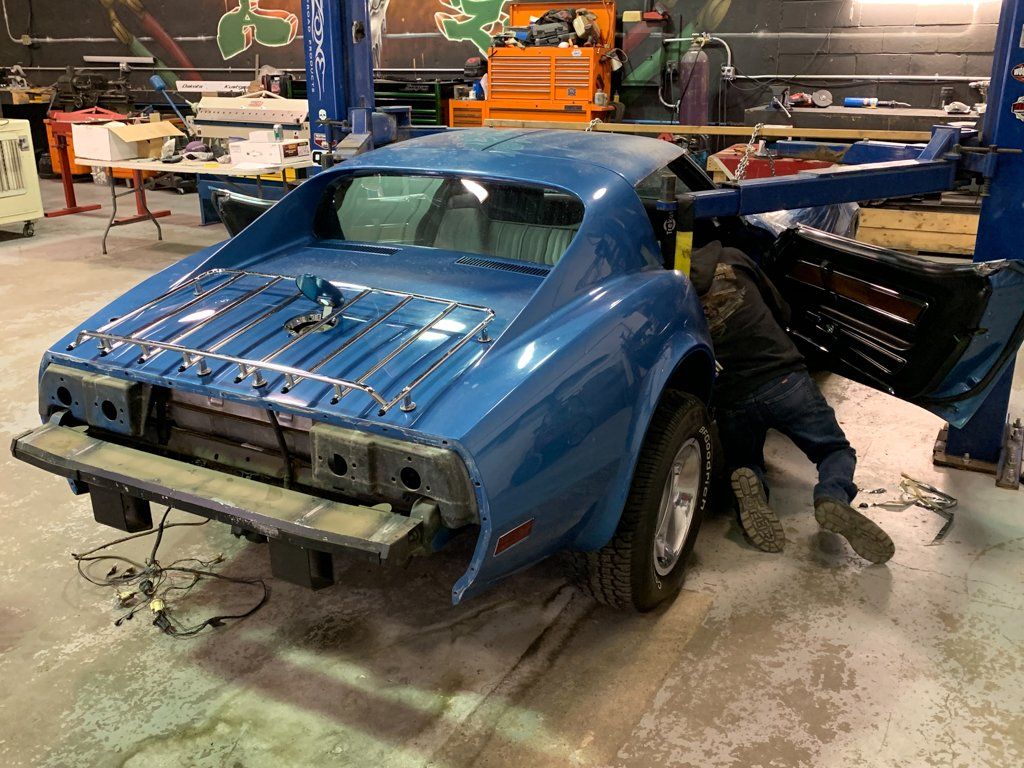 rear view of car suspended by chains