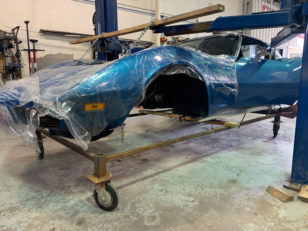 car body covered plastic suspended by chains