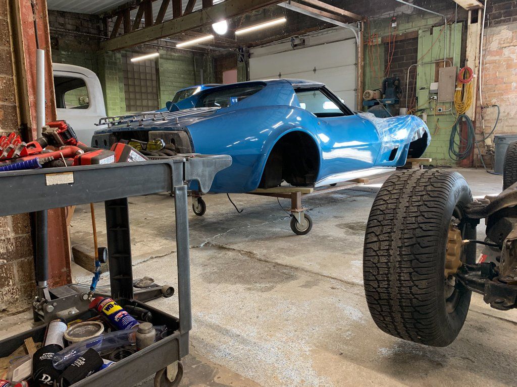 rear view of car body suspended next to service cart