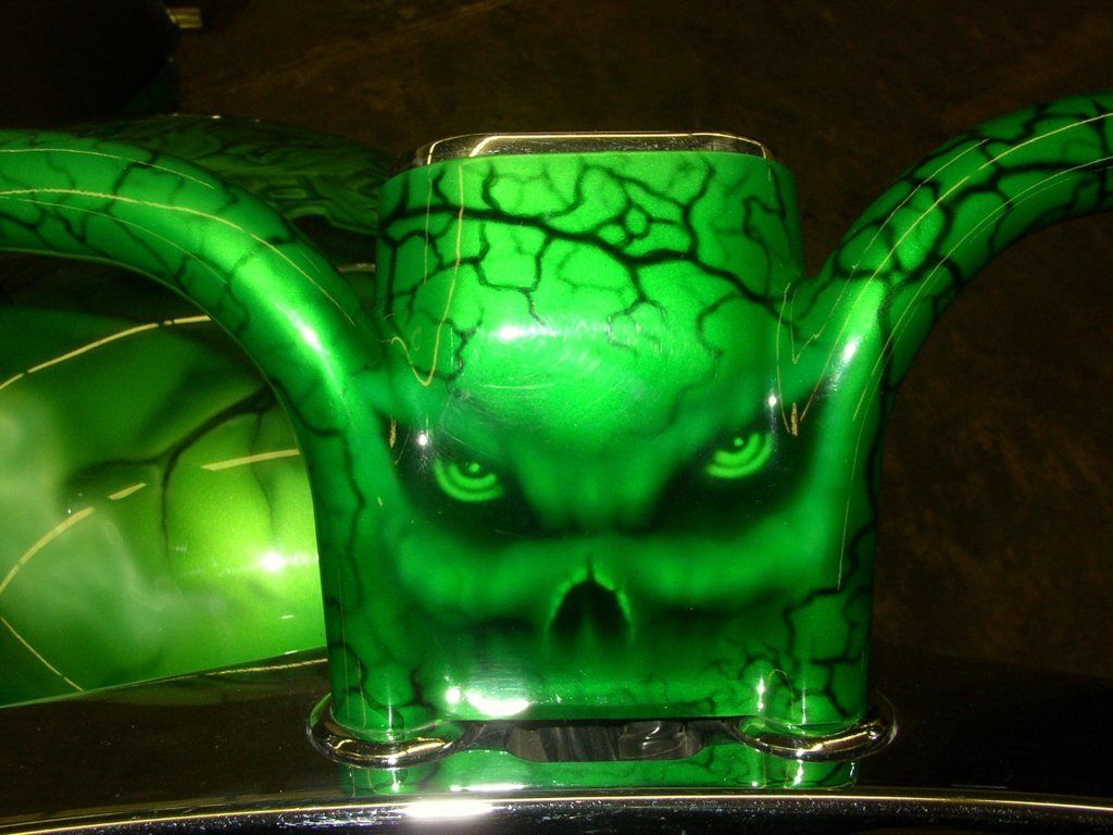 close up of green skull and vein design on chopper
