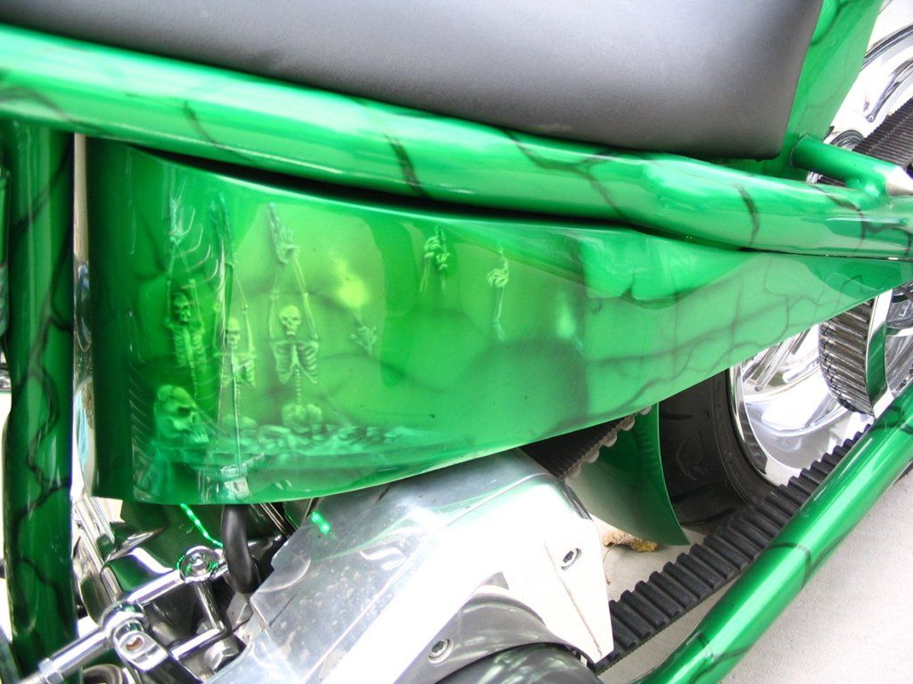 green motorcycle chopper side view of skeleton designs