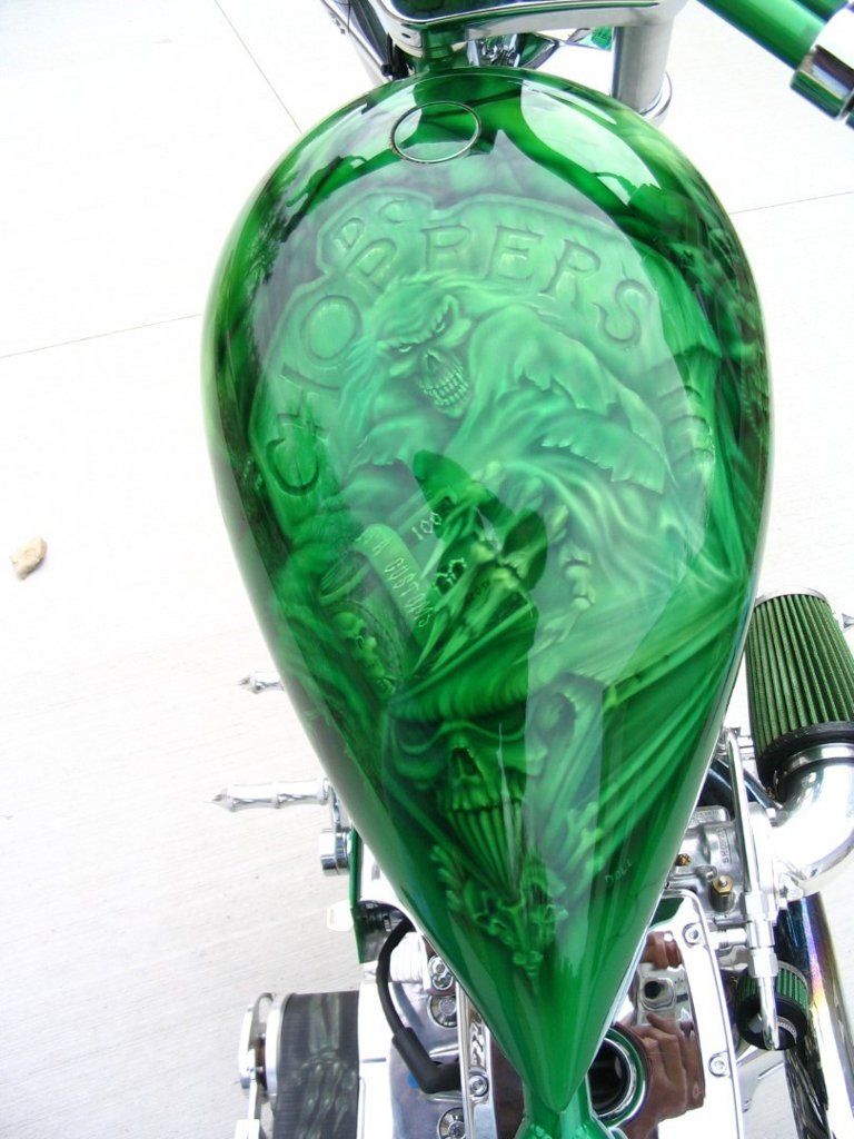 green motorcycle chopper fuel tank with skull designs