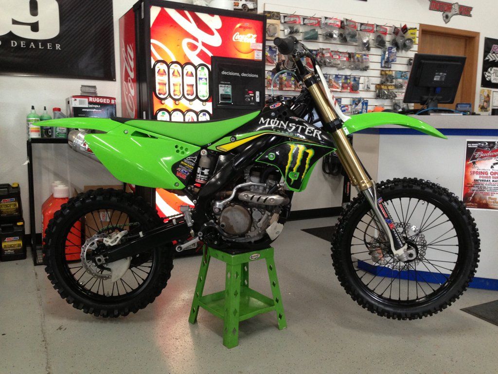 right side view of custom black and lime green bike with monster energy drink and oakley logo