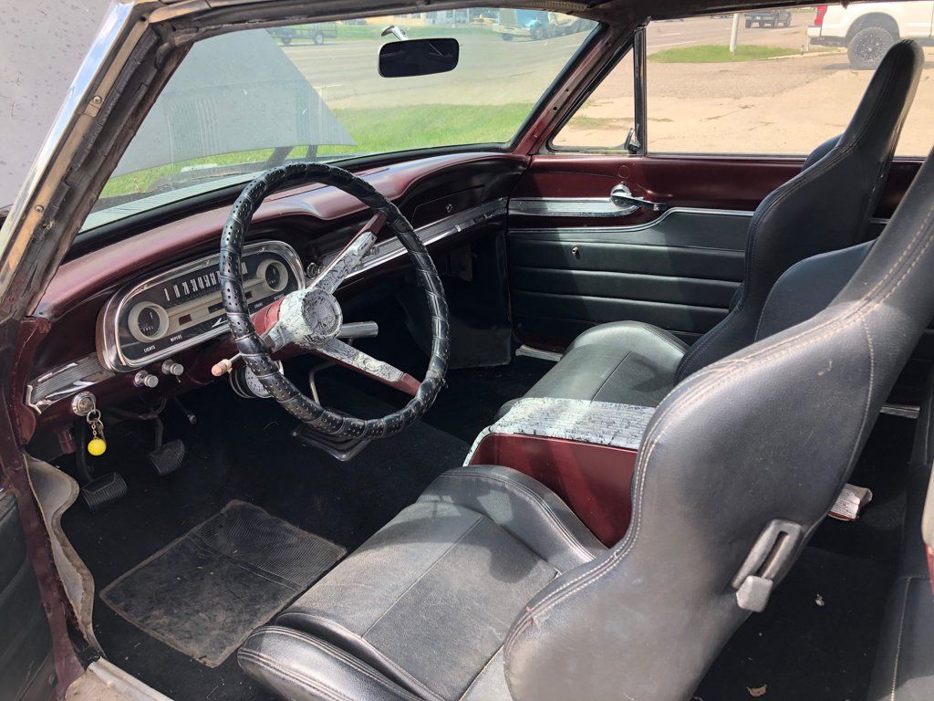 interior view of front seats, steering wheel, and dashboard