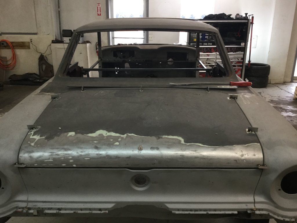 front view of car without paint in dark garage