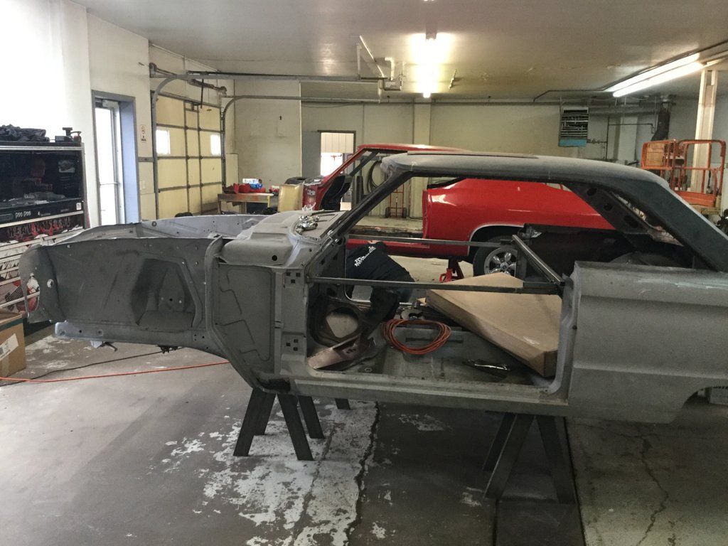 side view of car in service bay with no doors