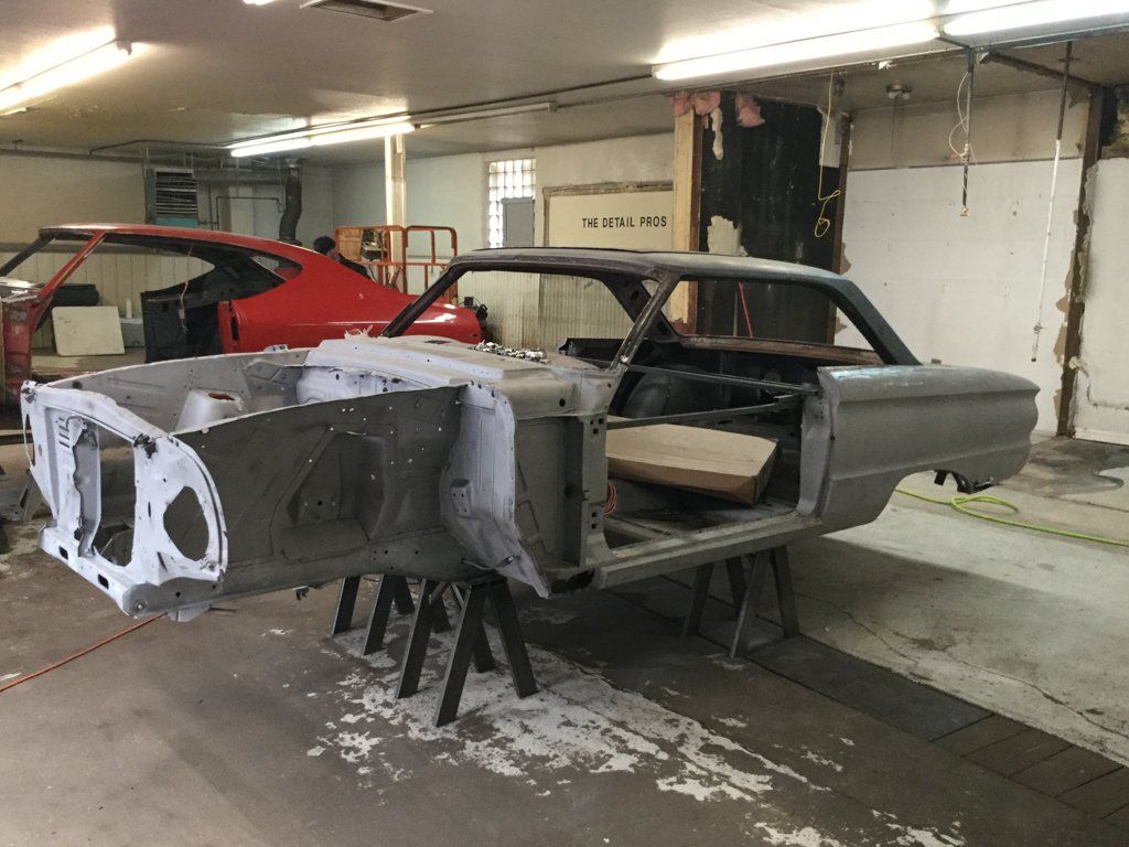 front side view of car in service bay with no doors