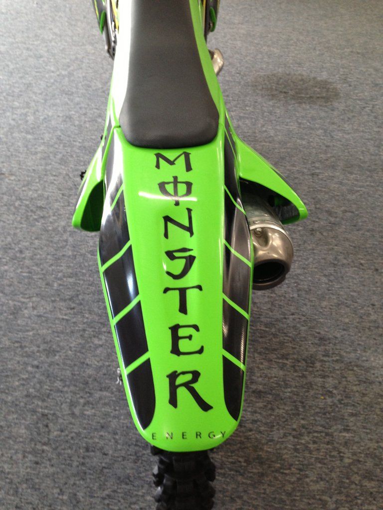 rear view of custom black and lime green bike with monster energy logo