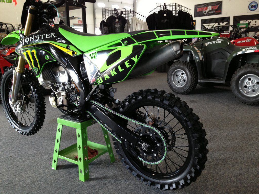 side view of custom black and lime green bike with monster energy drink and oakley logo