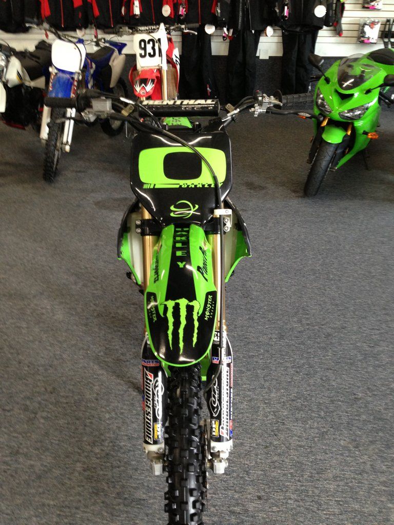 front view of custom black and lime green bike with monster energy drink logo