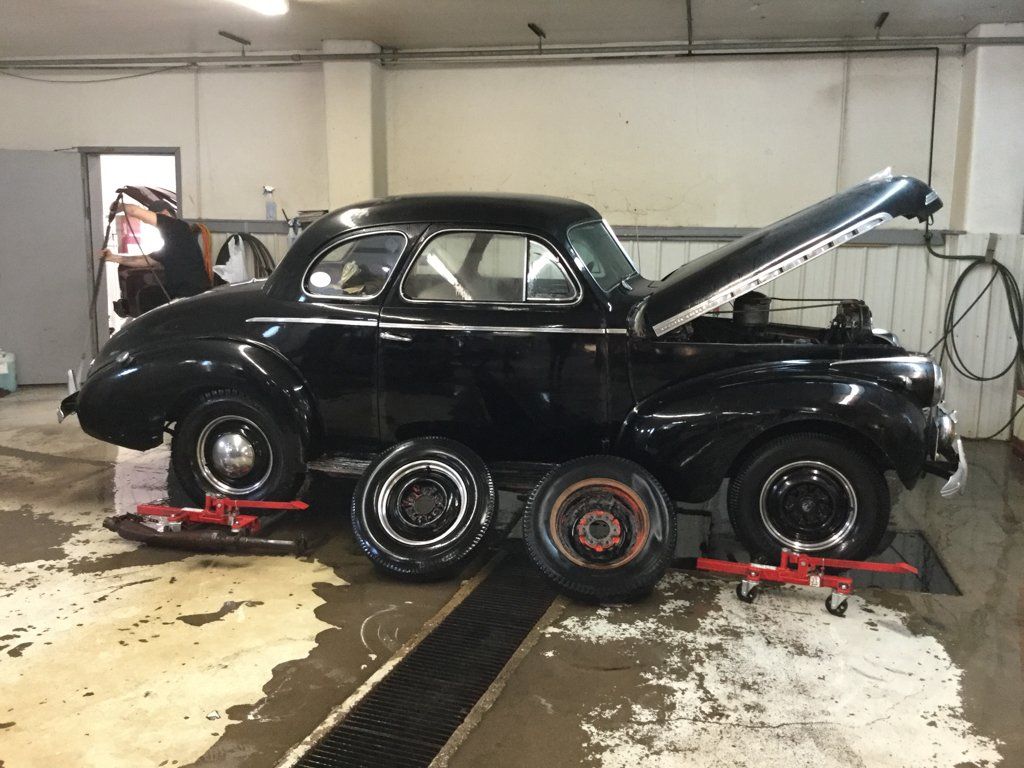 wheel being replaced and leaning on coupe