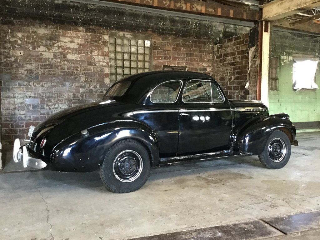 rear side view of black 1940 chevy special deluxe coupe