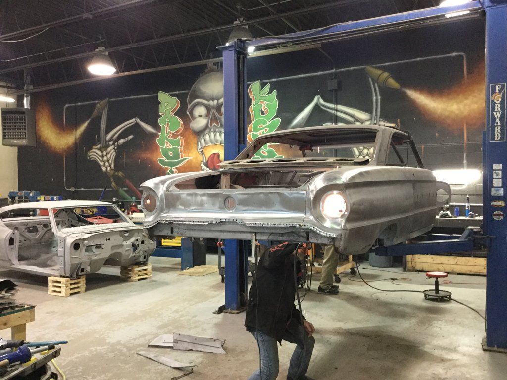 mechanic inspecting under side of car