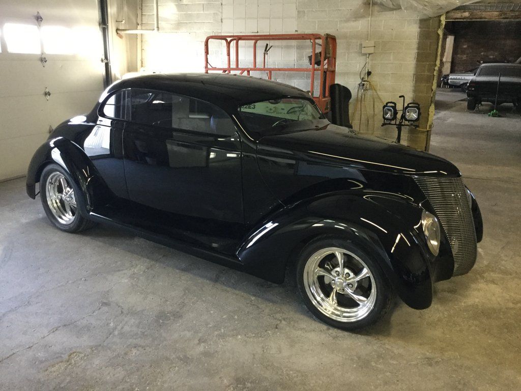 side profile view of custom black 1937 ford tudor hot rod