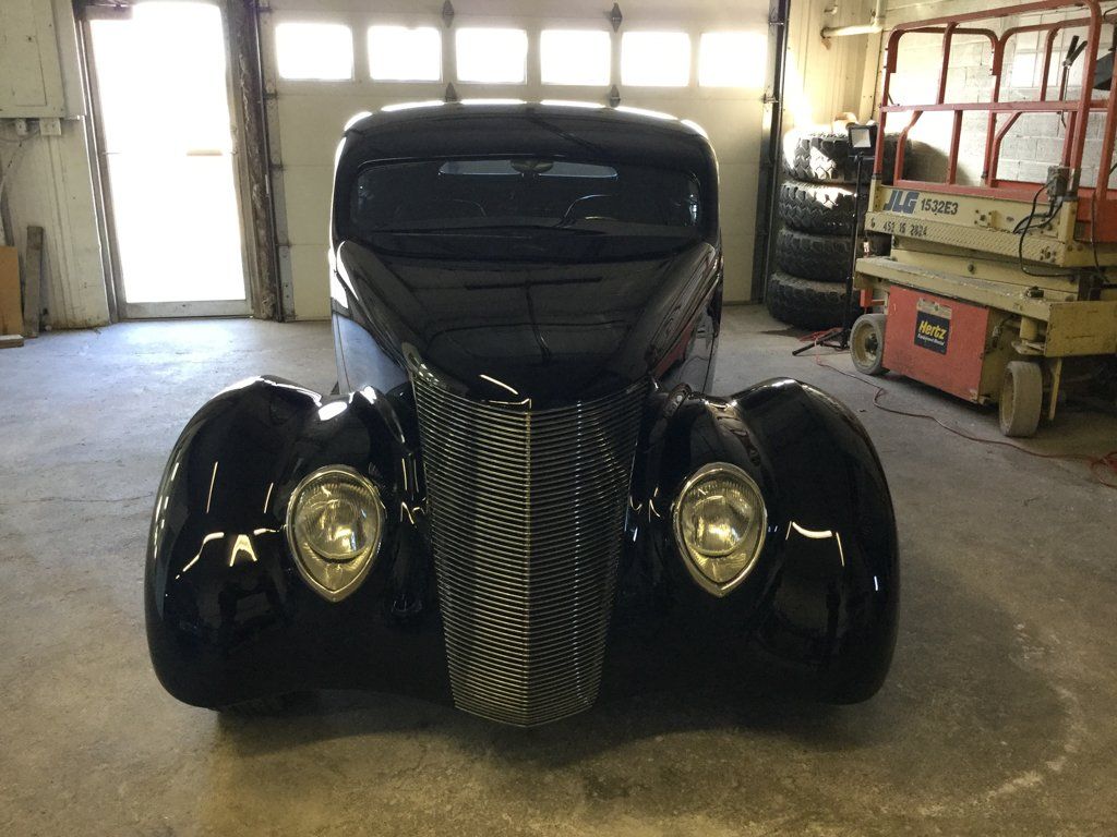 front view of custom black 1937 ford tudor hot rod