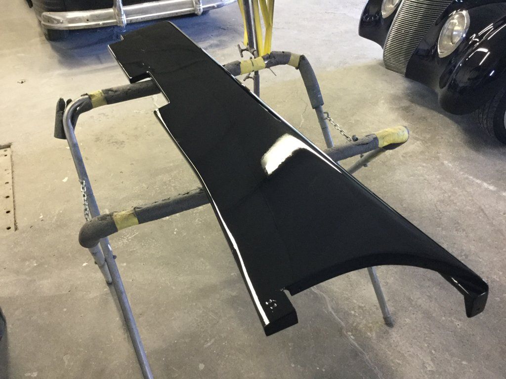 black painted panel suspended on piping