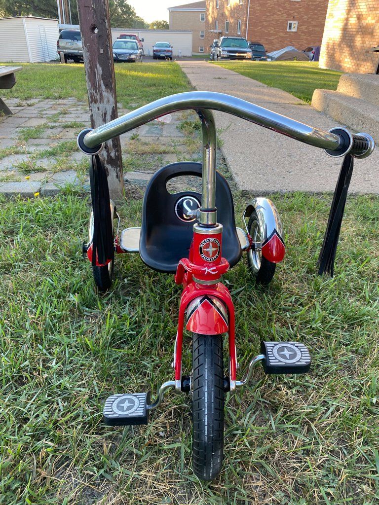 front view of custom red tricycle on grass